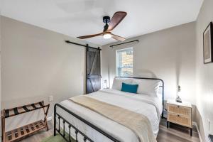 a bedroom with a bed with a ceiling fan at Newly renovated-across the street from Von Stiehl! in Algoma