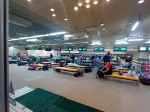 a group of people sitting on benches in a store at Tsubame Sanjo Local Stay KYU in Sanjo