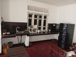 a kitchen with a counter and a sink and a window at Breeze House in Hikkaduwa