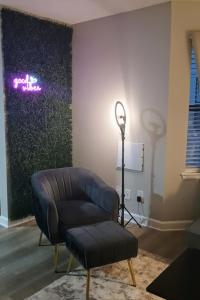 a living room with a leather chair and a lamp at The Serene Uptown Flat in Charlotte