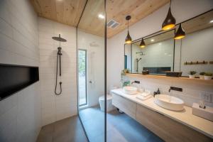 a bathroom with two sinks and a large mirror at Chalet OSLO in Saint Come
