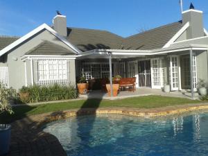 a house with a swimming pool in front of it at brookdale house in Cape Town