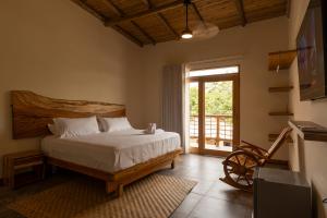 a bedroom with a bed and a sliding glass door at Casa Barú in Barú
