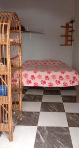 a bedroom with a bed and a checkered floor at Loft in El Tabo