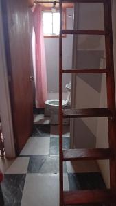 a bathroom with a ladder leading to a toilet at Loft in El Tabo