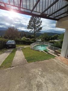 a car parked next to a house with a swimming pool at Bendecida in San Antonio de Arredondo +5 photos