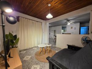 a living room with a bed and two stools at Departamento dos dormitorios en 3er piso por escaleras in Chajarí