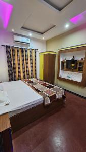 a bedroom with a bed and a large window at Oudh blooms in Shoranūr