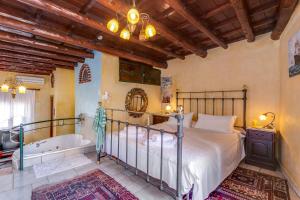 a bedroom with a bed and a bath tub at Ifigenia Traditional Rooms & Maisonettes in Chania