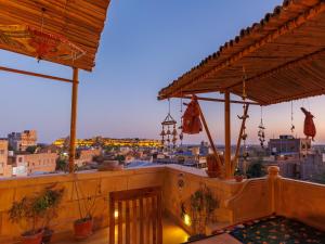a balcony with a view of a city at dusk at Hotel The Silk Route in Jaisalmer