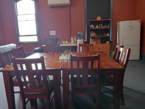 a dining room with a wooden table and chairs at Australia Hotel Fremantle in Fremantle