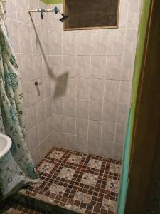 a bathroom with a shower with a tiled floor at Casa Luna in El Remate +8 photos