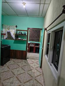 a room with blue walls and a tile floor at Casa Luna in El Remate