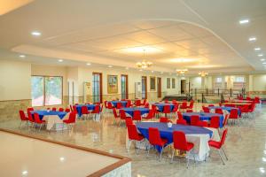 a banquet hall with blue and red tables and chairs at Grand Melka Hotel in Lovina +39 photos
