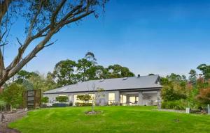 a large white house with a green yard at The Grand Oasis in Donvale