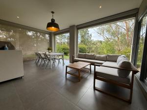 a living room with a couch and a table at The Grand Oasis in Donvale