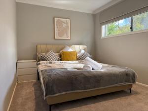 a bedroom with a large bed with a window at The Grand Oasis in Donvale