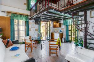 a living room with a table and chairs at Ifigenia Rooms in Chania