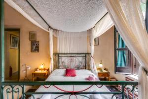 a bedroom with a large bed with a red pillow at Ifigenia Rooms in Chania