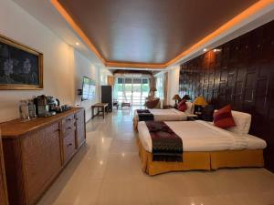 a hotel room with two beds and a kitchen at Rainbow Arokaya Welness Resort in Ban Hua Sai