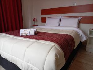 a large white bed in a hotel room at Belys inn in Cusco