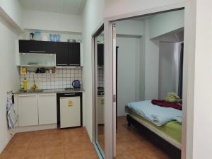 a room with a kitchen and a bed in it at AvataraA B32 by malai in Ban Tha Fat