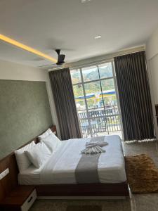 a bedroom with a bed and a large window at Dreamwagon hotel lakkidi in Vythiri +9 photos