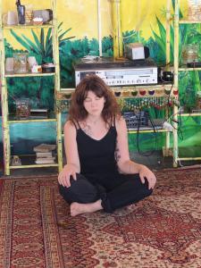 a woman sitting on the floor in a room at The Cave house hostel in Cochin