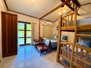 a bedroom with a bunk bed and a desk at Baan Chan Lay Koh Chang in Ko Chang