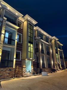 a large building with lights on it at night at Sunset Hideout Kulambiro in Kampala