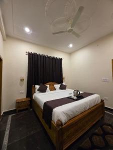 a bedroom with a large bed with a ceiling at Pi Palace in Bhīm Tāl