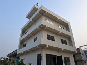 a white building against a blue sky at Vamika Palace in Ayodhya +21 photos