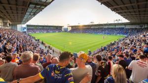 a crowd of people in a stadium watching a soccer game at 2BR Apt By Eason Stays Short Lets Warrington in Warrington