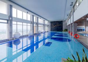 a large swimming pool in a building with a view at A Quiet Stay - Service Apartment, Vinhome Ocean Park, Ha Noi in Gia Lâm Pho