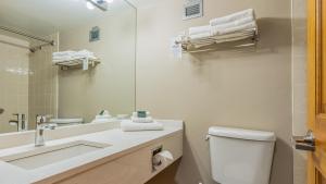 a bathroom with a sink and a toilet and a mirror at Cahilty #247 in Sun Peaks