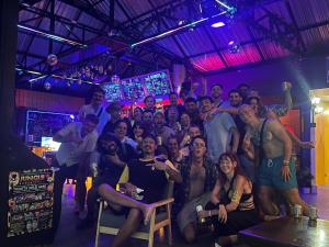 a group of people posing for a picture in a club at MBAR HOSTEL HAAD RIN in Haad Rin