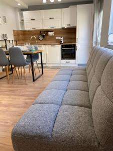 a living room with a couch and a kitchen at Студио Ирма in Burgas