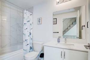 a bathroom with a toilet and a sink and a shower at Downsview Park Luxury Townhome near Yorkdale Transit in Toronto +60 photos