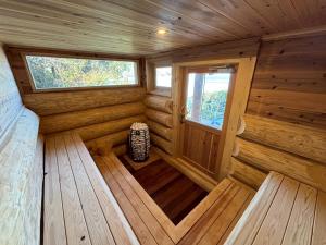 an inside view of a wooden cabin with two windows at 椿ハウス 海の見えるサウナ付き貸切別荘 in Anan