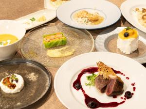 a bunch of plates of food on a table at Nature Base Hotel NUPPUKOTTE in Teshikaga