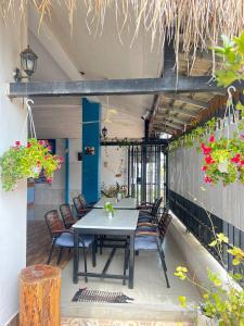 a table and chairs on a patio with flowers at Grand Apsara Residence in Siem Reap