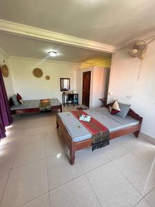 a room with two beds and a table in it at Grand Apsara Residence in Siem Reap
