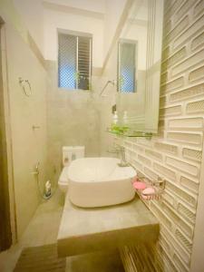 a bathroom with a sink and a toilet at Delmar Homestay in Dickwella