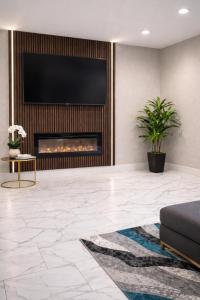 a living room with a fireplace and a television at Chaparral Motor Inn in Burlington
