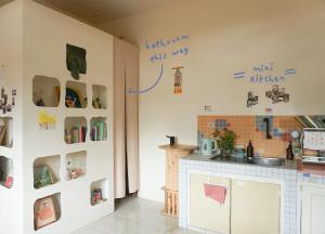 a kitchen with writing on the wall at MiTS in Bandung