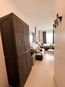 a living room with a large closet and a couch at BES Building in Dasmariñas
