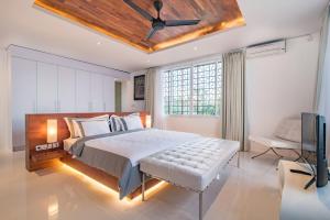 a bedroom with a large bed with a ceiling fan at Villa Kamag Seminyak in Seminyak