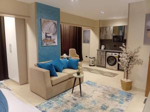 a living room with a couch and blue pillows at MIRA Holiday Home in Cairo
