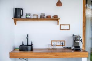 a kitchen counter with a coffee maker on a shelf at Teman Private villa with pool in Gili Islands