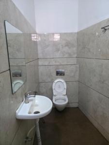 a bathroom with a sink and a toilet at Hotel Right Choice in Indore +34 photos